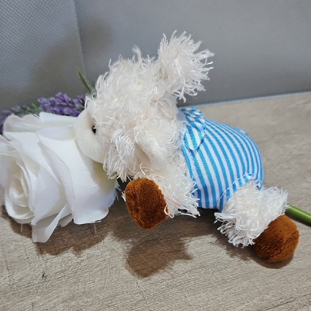 Doodalou Plush Lamb Pacifier Holder With Blue Striped Bathing Suit.